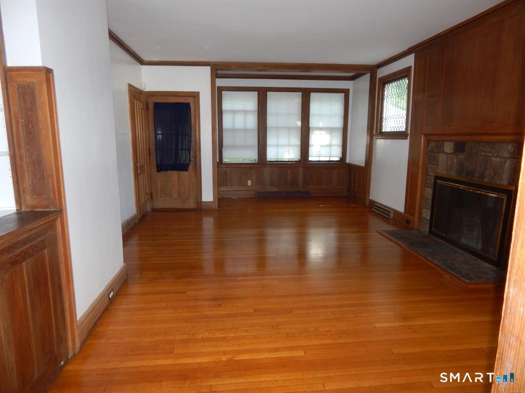 5 Clover Street Ansonia, CT 06401 - Photo 7 of 10 a view of an empty room with wooden floor and a window