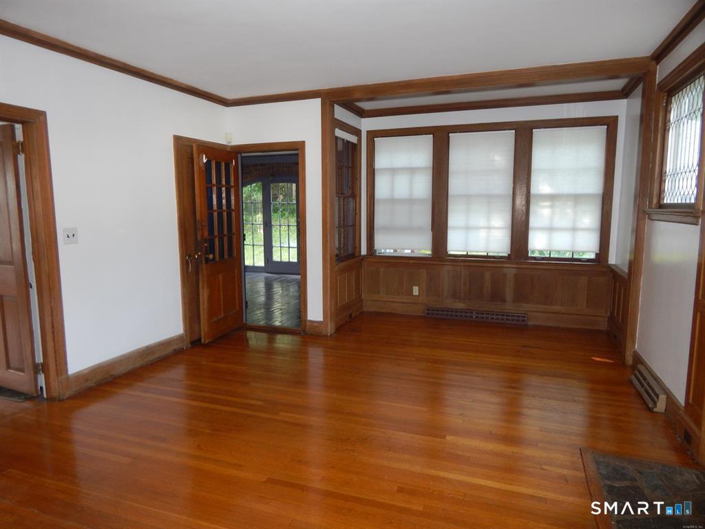 5 Clover Street Ansonia, CT 06401 - Photo 9 of 10 a view of an empty room with wooden floor and a window