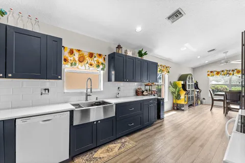 a kitchen with a sink a stove and cabinets