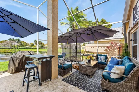a view of an outdoor sitting area with furniture and umbrella