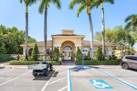 a front view of a house with garden and parking