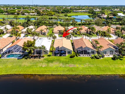 an aerial view of residential houses with outdoor space and swimming pool