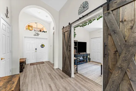 a view of a hallway view with wooden floor and furniture