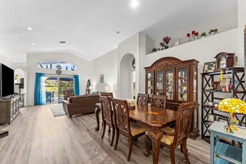 a view of a dining room with furniture and chandelier