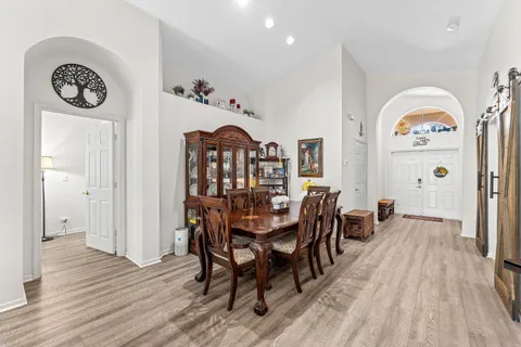 a view of a dining room with furniture and wooden floor