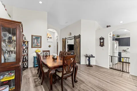 a view of a dining room with furniture and wooden floor