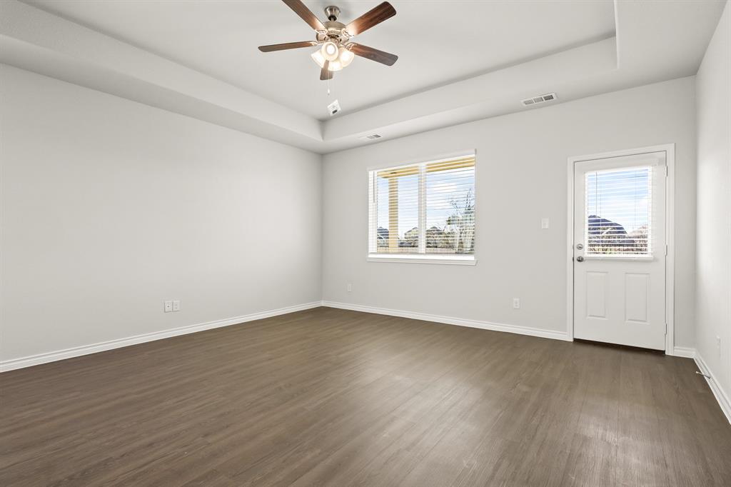 5025 Wellborn Road Crowley, TX 76036 - Photo 6 of 38 a view of an empty room with wooden floor and a window