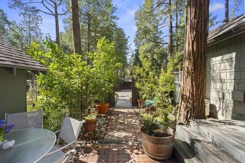 a view of a house with backyard and sitting area