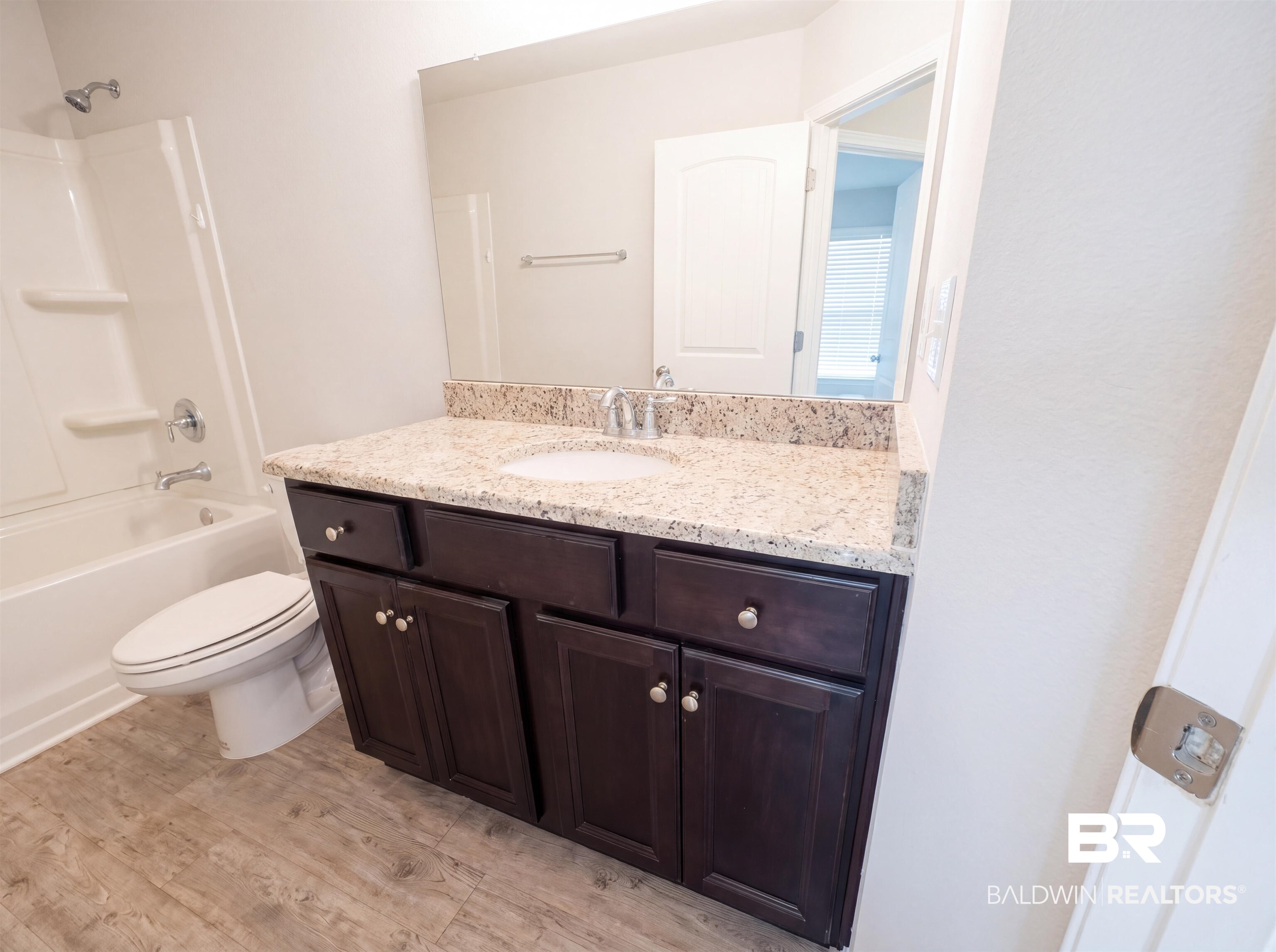 1740 Covington Lane Foley, AL 36535 - Photo 12 of 18 Bathroom featuring a dark wood vanity with a light-colored speckled countertop, an integrated sink, and chrome fixtures