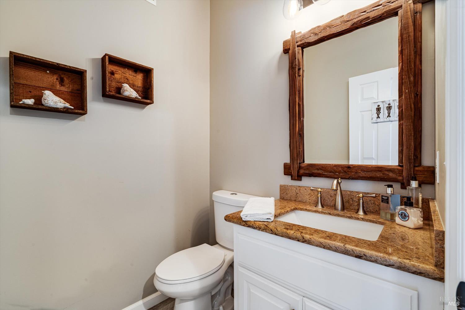 2980 Warm Springs Road Glen Ellen, CA 95442 - Photo 15 of 59 a bathroom with a granite countertop sink and a mirror