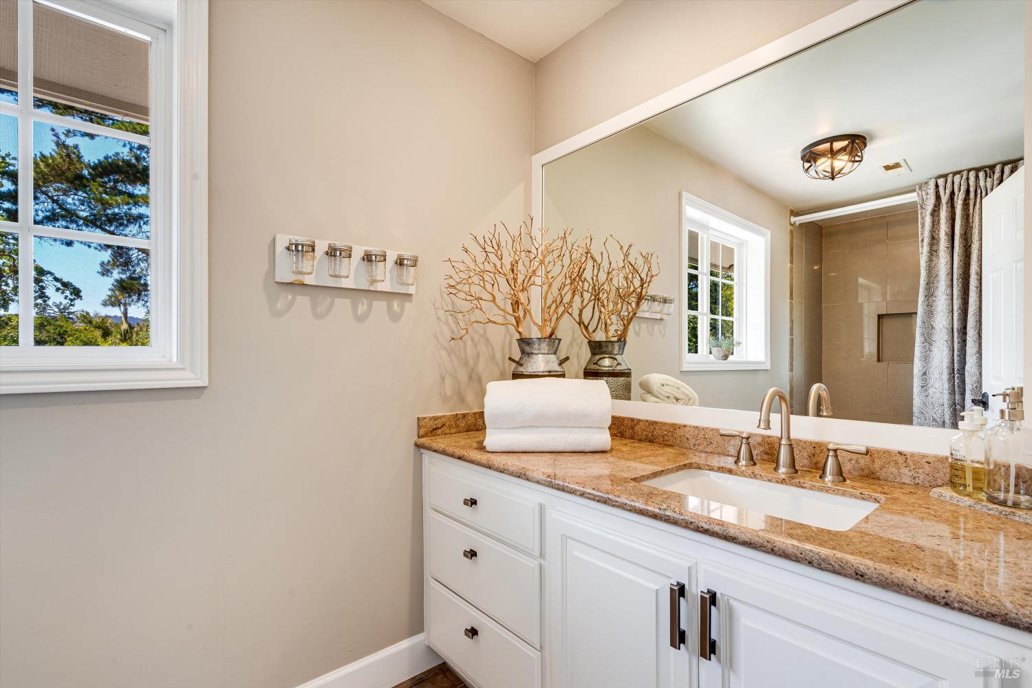 2980 Warm Springs Road Glen Ellen, CA 95442 - Photo 49 of 59 a bathroom with a granite countertop sink and a mirror