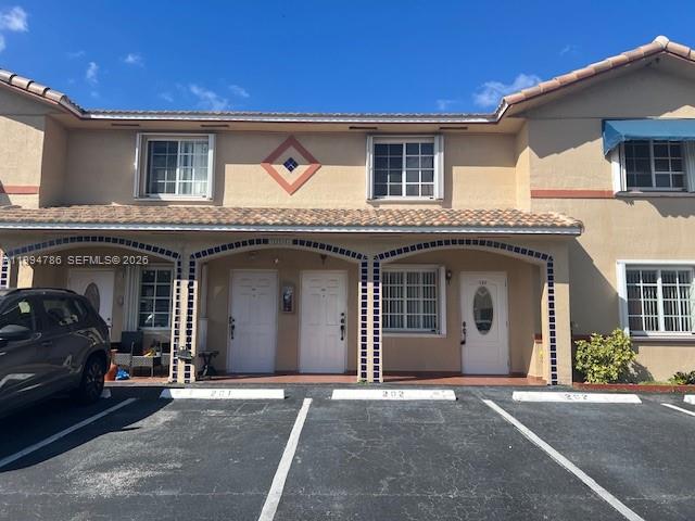 3260 West 70th Street, Unit 202 Hialeah, FL 33018 - Photo 1 of 20 a view of a car parked in front of a building