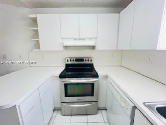 3260 West 70th Street, Unit 202 Hialeah, FL 33018 - Photo 4 of 20 a kitchen with granite countertop a stove sink and cabinets