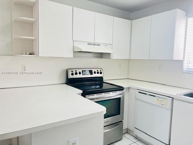 3260 West 70th Street, Unit 202 Hialeah, FL 33018 - Photo 5 of 20 a kitchen with granite countertop white cabinets and white appliances