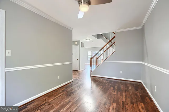 a view of room with window and wooden floor