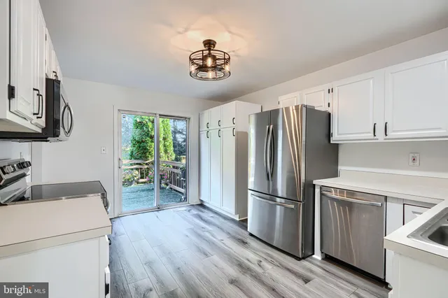 a kitchen with stainless steel appliances a refrigerator stove and sink