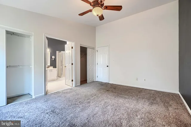 a spacious bathroom with a bathtub a sink and a large mirror