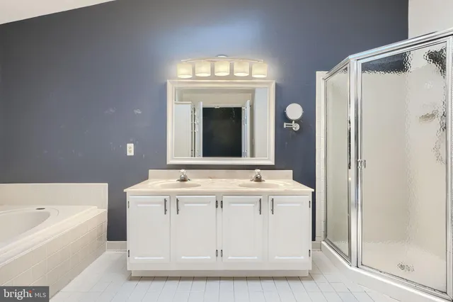 a bathroom with a tub sink and mirror