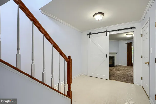 a view of an empty room with a fireplace and a window