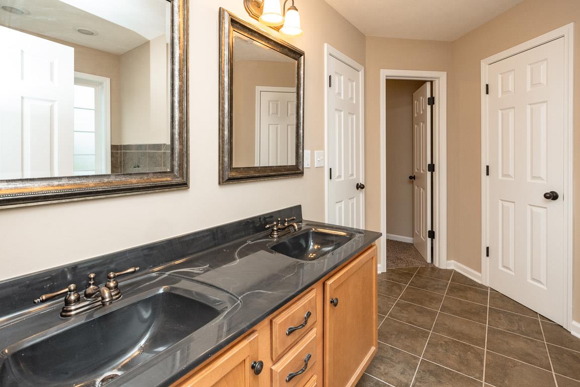 1498 Raven Road Clarksville, TN 37042 - Photo 14 of 30 a bathroom with a sink and a mirror
