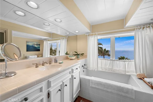 a spacious bathroom with a double vanity sink and a bathtub