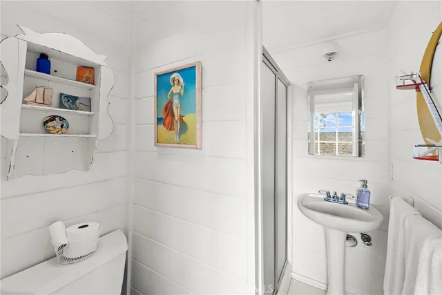 a bathroom with a sink a mirror and a toilet