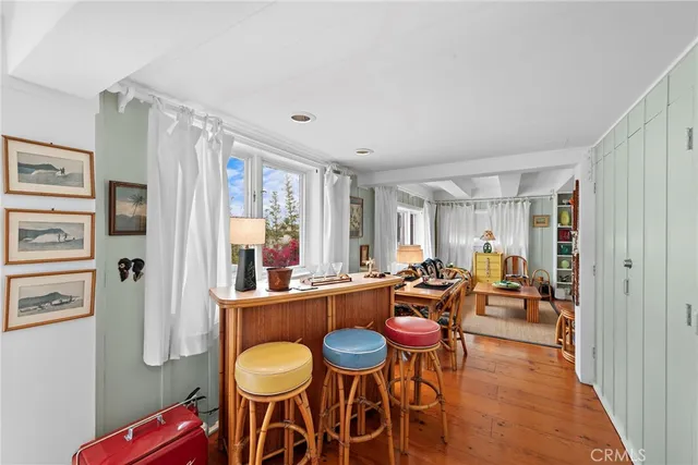 a dining room with furniture and wooden floor