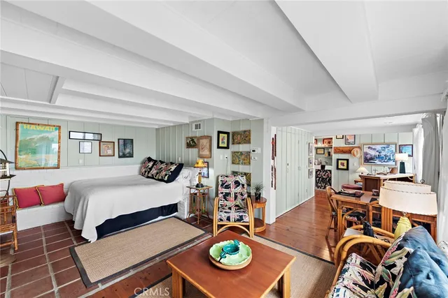 a bedroom with furniture and a wooden floor