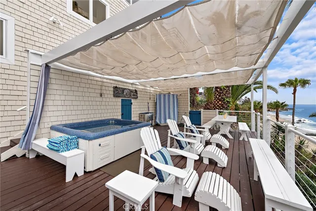 a view of a patio with table and chairs with wooden floor and fence
