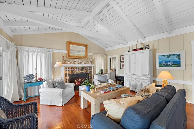 a living room with furniture a fireplace and a table