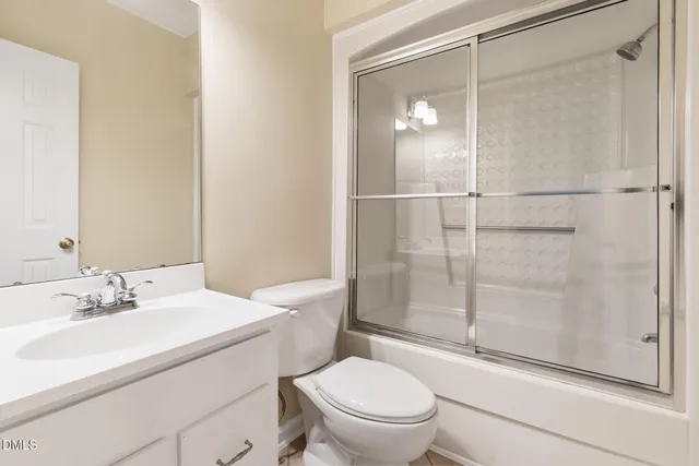 a bathroom with a toilet a sink and shower