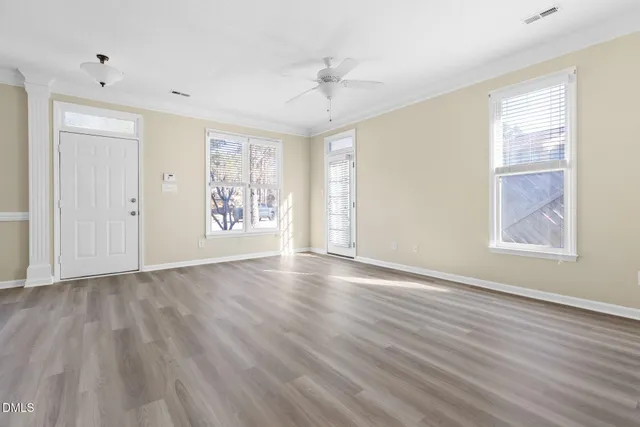 wooden floor in an empty room with a window