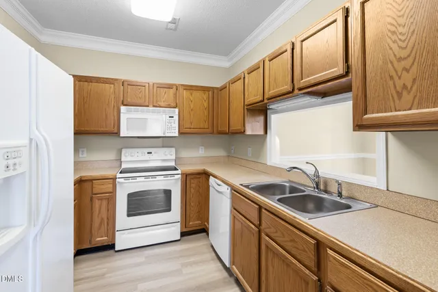a kitchen with stainless steel appliances granite countertop a sink and a stove