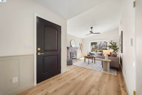 a dining room with wooden floor a chandelier a wooden table and chairs