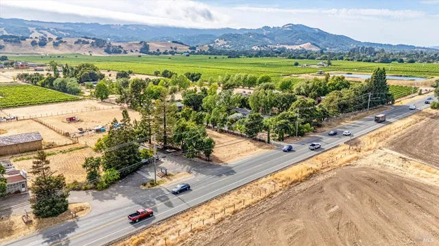 an aerial view of residential houses with outdoor space and river