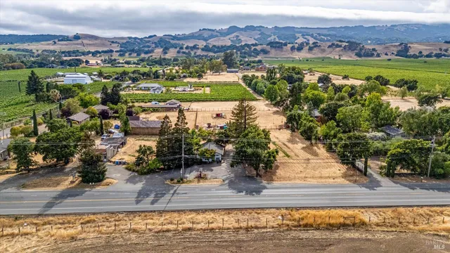 an aerial view of a house with a garden and lake view