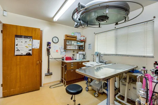 a view of a workspace with furniture and a window