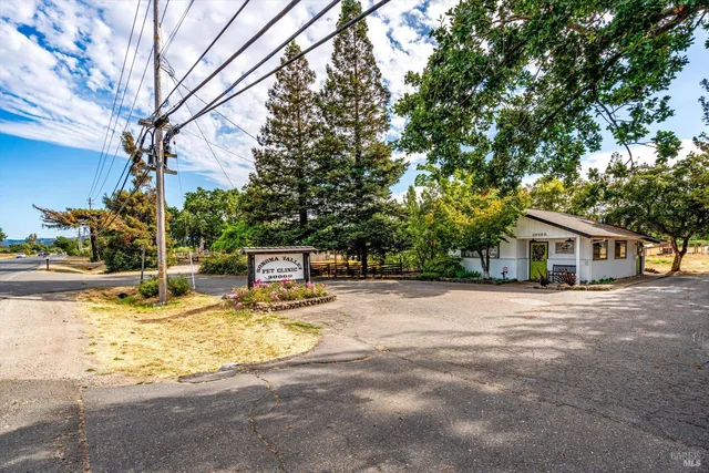 a view of a house with pool and sitting area