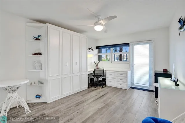 a view of a building with a yard and palm trees
