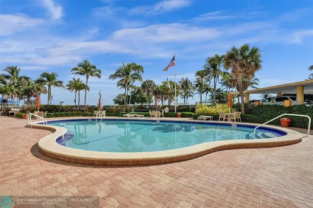 a living room with furniture and large windows