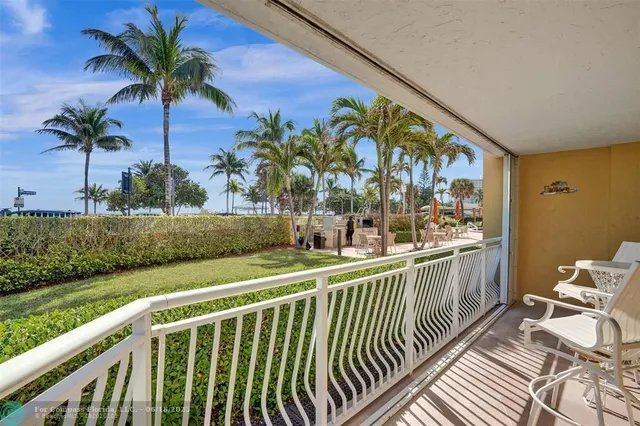 a large white kitchen with lots of counter space and stainless steel appliances