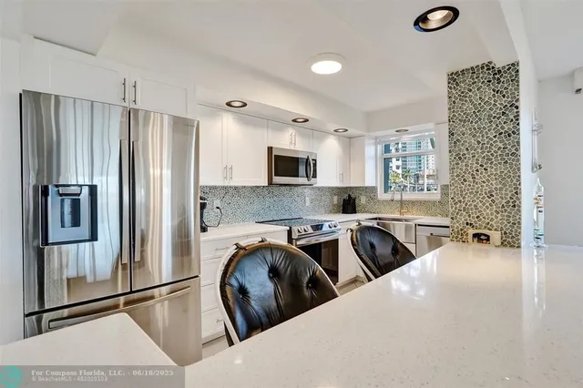 a kitchen with a stove a microwave and refrigerator