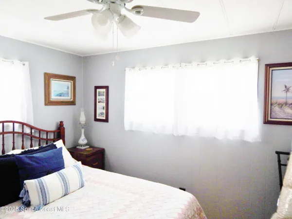 a bedroom with a bed couch and window