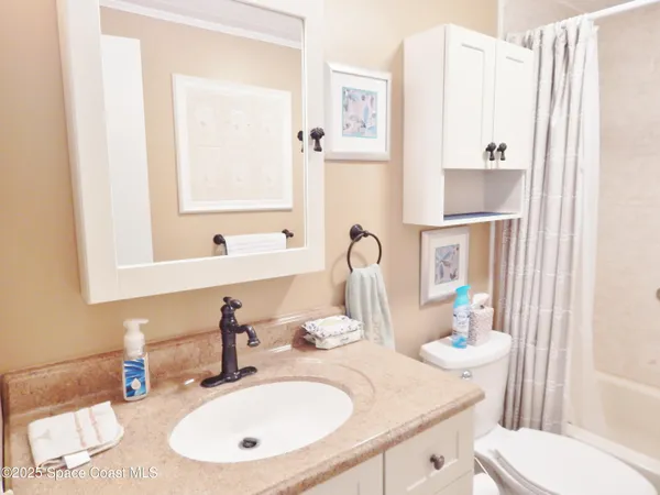 a bathroom with a sink toilet and mirror