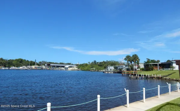 a view of a lake with houses in the back
