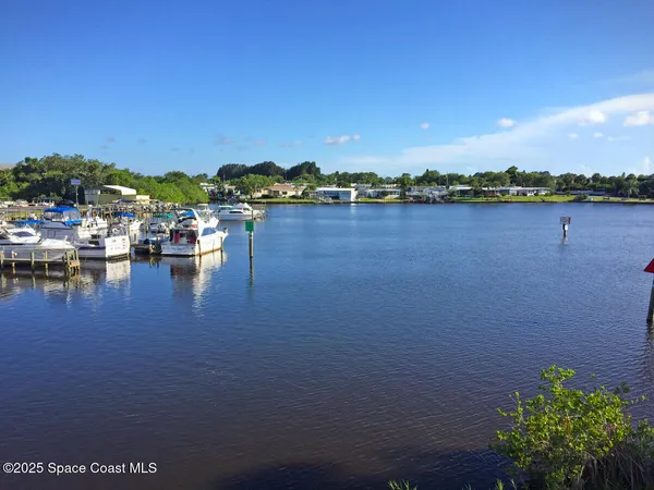 a view of a lake with a table and chairs