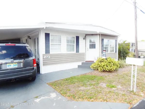 a living room with a bed and a chandelier