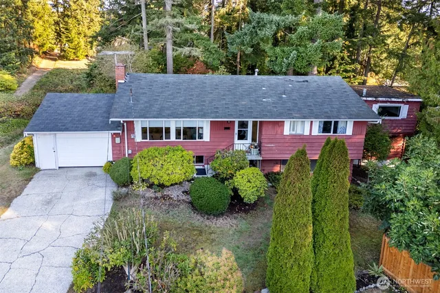 a aerial view of a house with a yard and plants