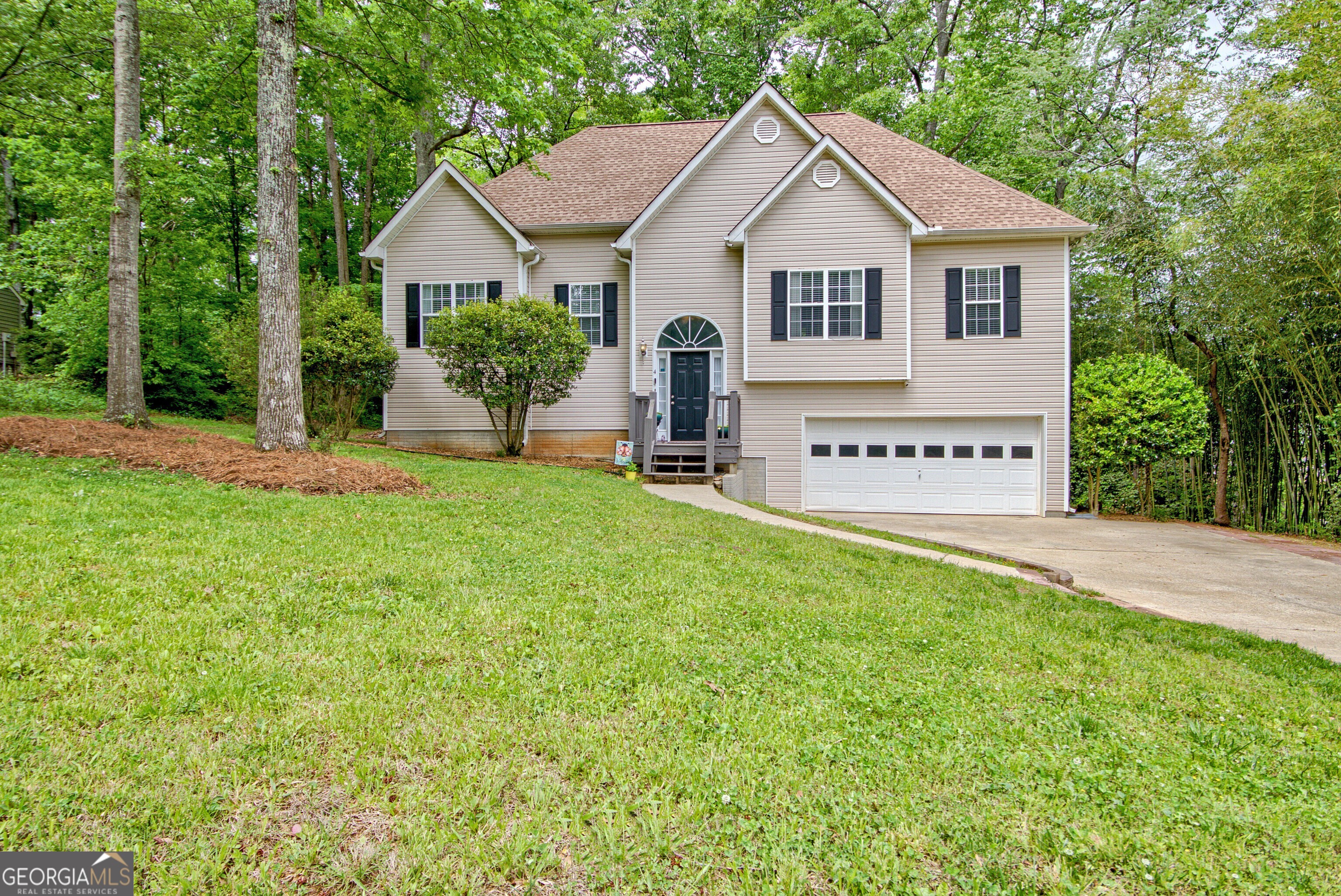 a view of a house with a yard and fence