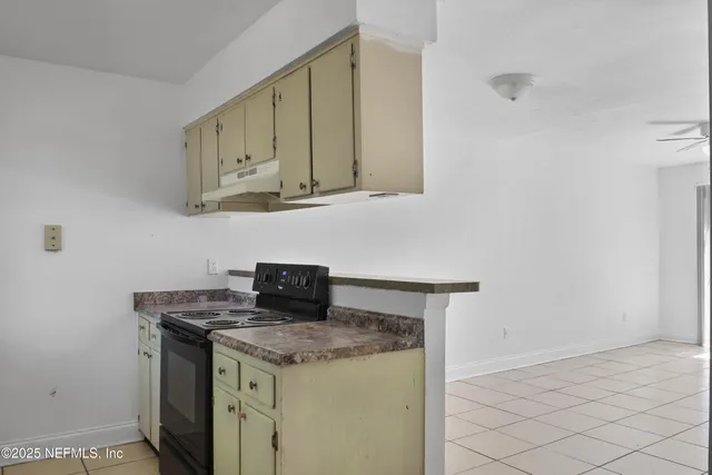 a kitchen with stainless steel appliances granite countertop a sink and a stove